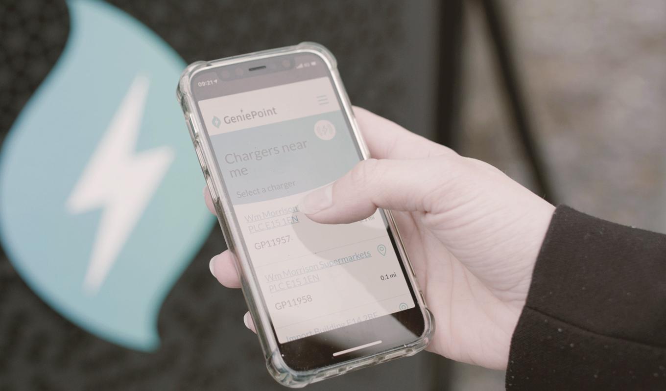 person using Genie Point charging app on mobile phone