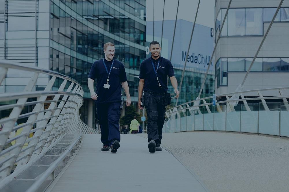 Two Equans employees walking