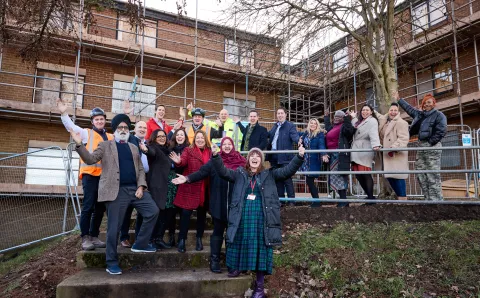All partners involved in the project on site to celebrate the start of the next phase - stood in front of scaffolding